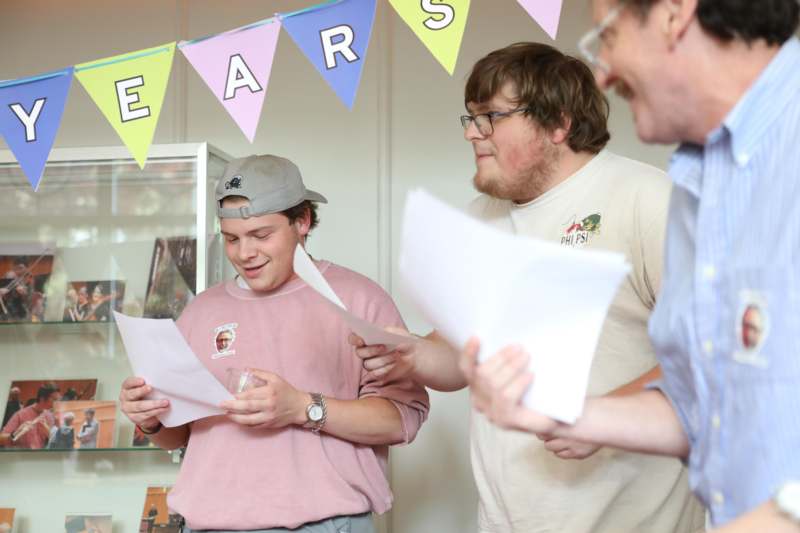 a group of men holding papers