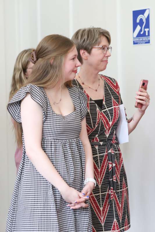 a woman taking a selfie with a woman