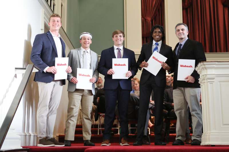 a group of men holding signs