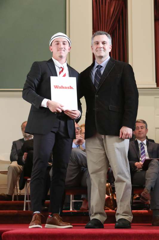two men standing on a stage