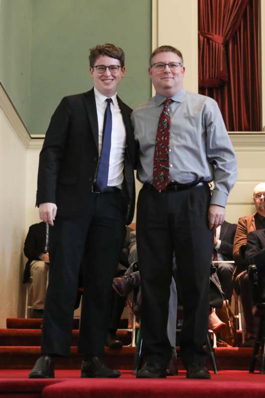 two men standing on stairs