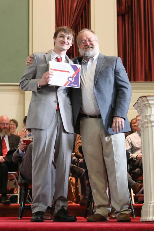 two men standing together and smiling