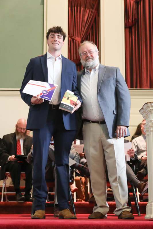 two men standing on a stage