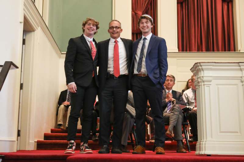 a group of men standing on a red carpet