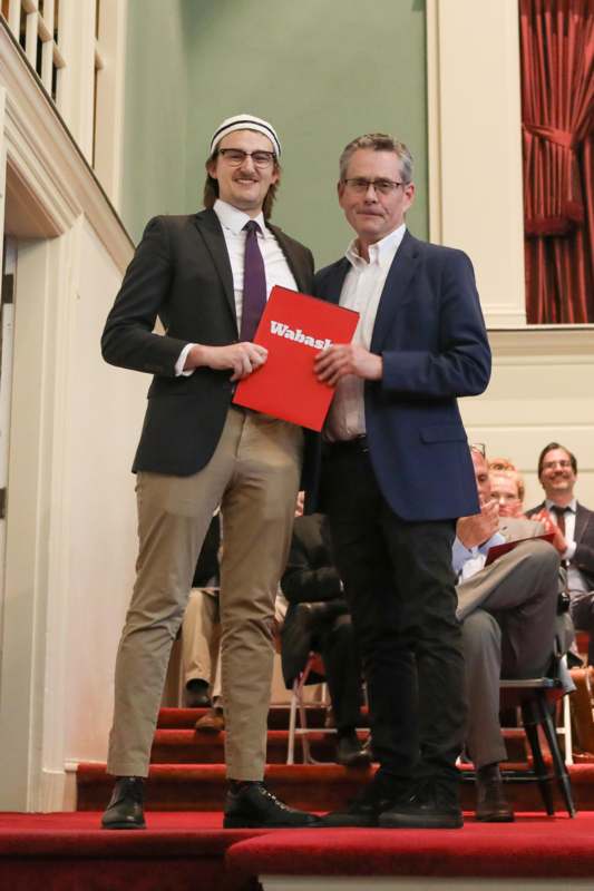 two men standing on stairs