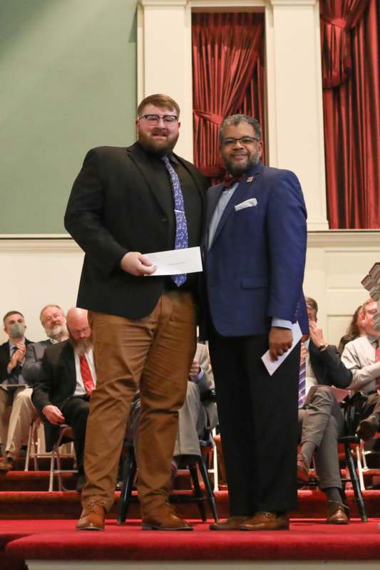 two men standing on a stage
