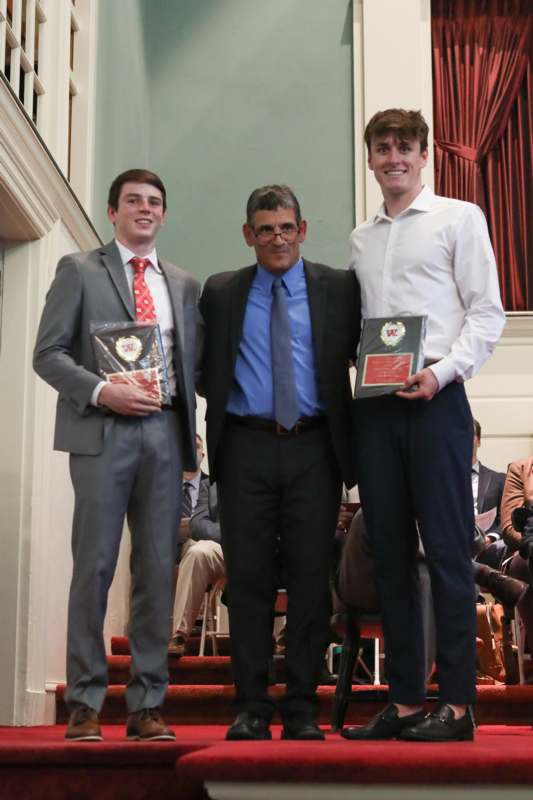 a group of men holding awards