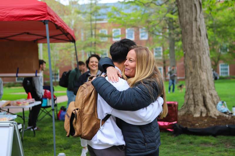 a woman hugging a man outside