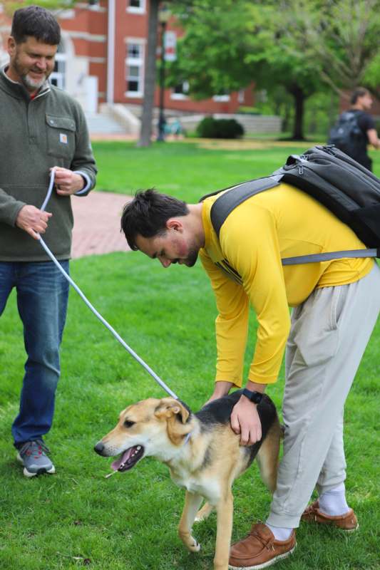 a man with a dog on a leash