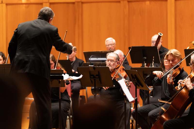 a man in a suit playing instruments