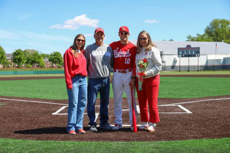 a group of people standing on a baseball field