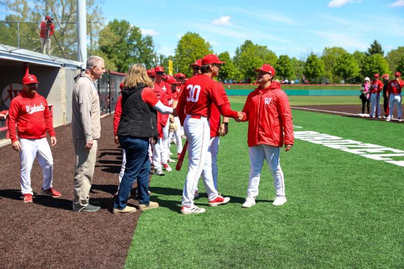 a group of people shaking hands on a field