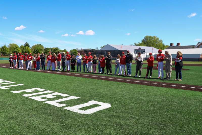 a group of people standing in a line on a field