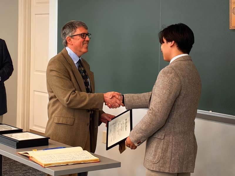 a man shaking hands with another man