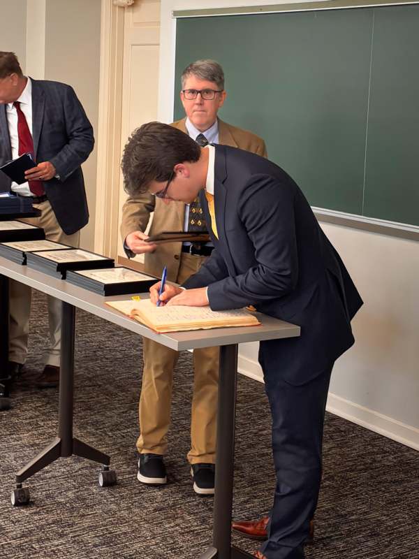 a man writing on a book