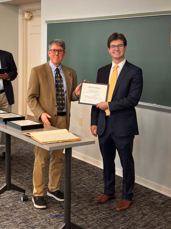 a man holding a certificate