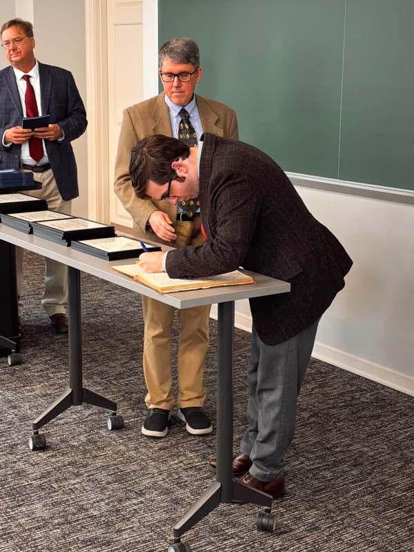 a man signing a book