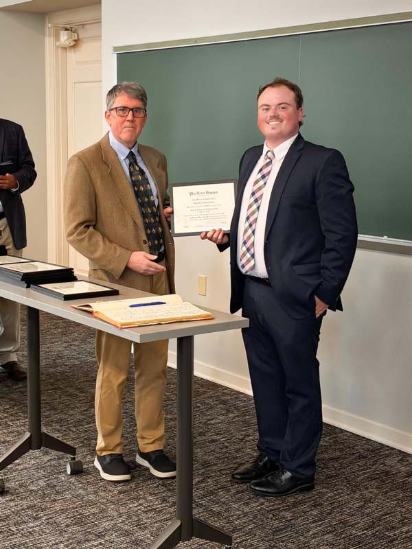 a man holding a certificate
