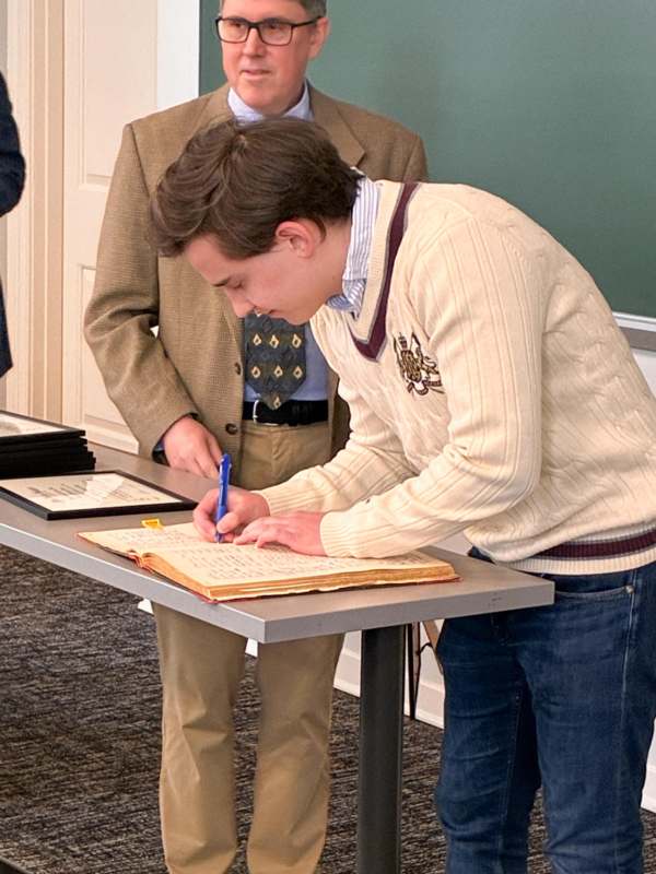 a man writing on a book