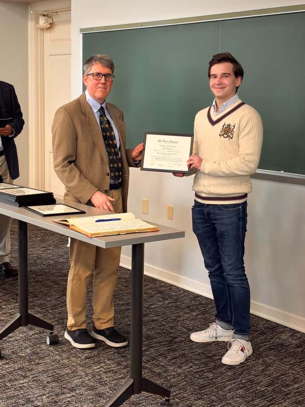 a man holding a certificate