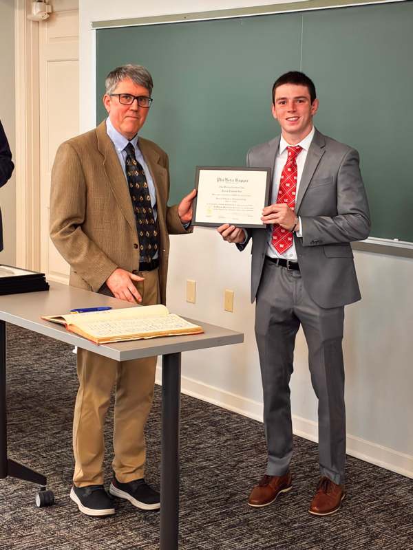 a man holding a certificate