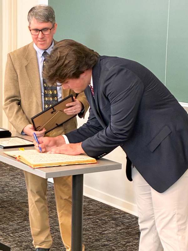 a man signing a document