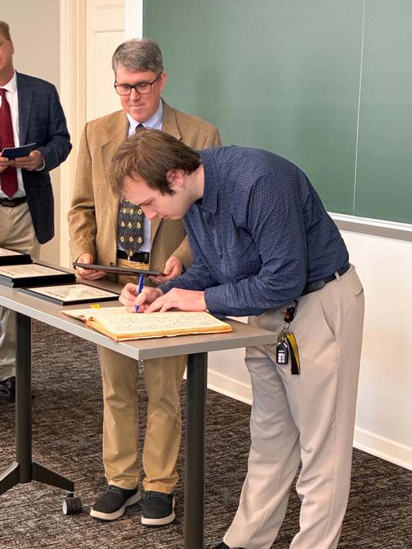 a man signing a document