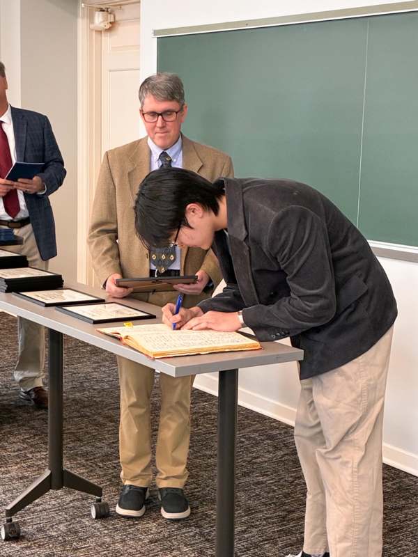 a man signing a book
