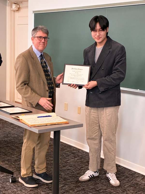 a man holding a certificate