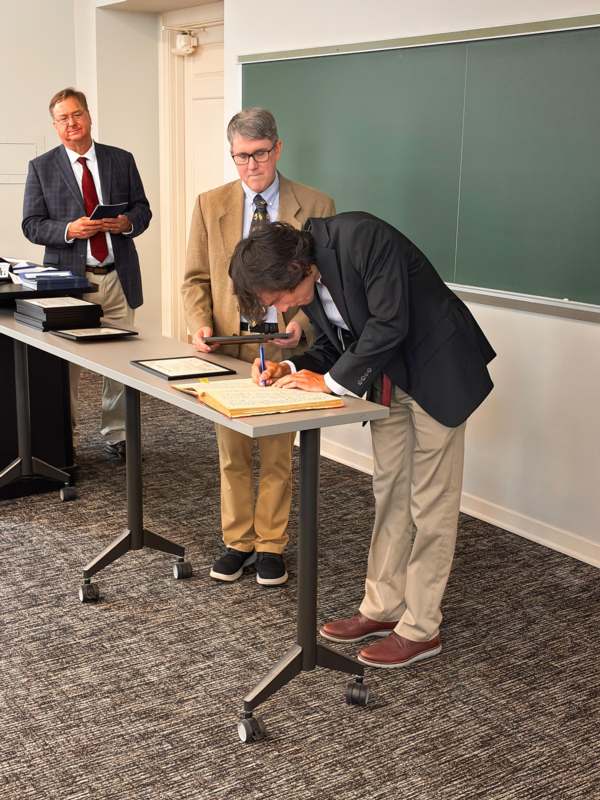 a man signing a document