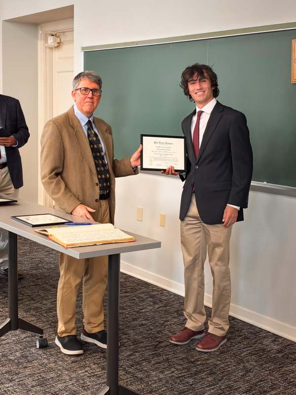 a man holding a certificate