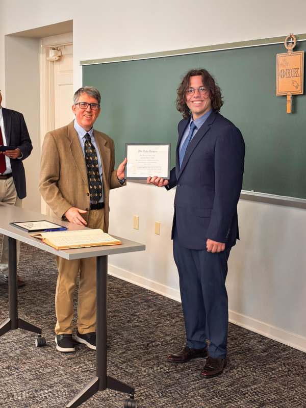 a man holding a certificate