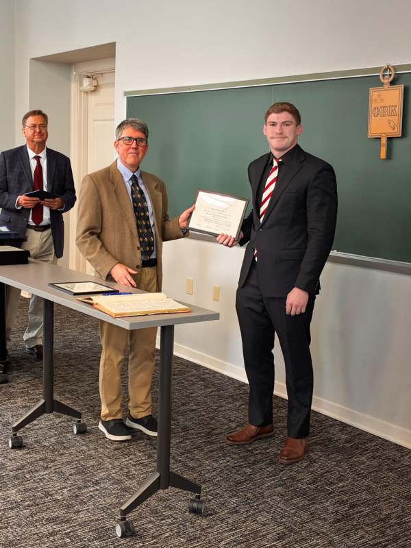 a man holding a certificate