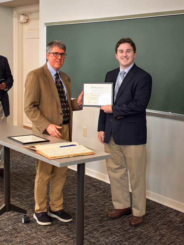 a man holding a certificate