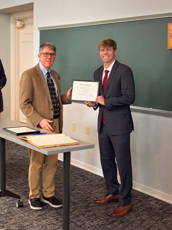 a man holding a certificate