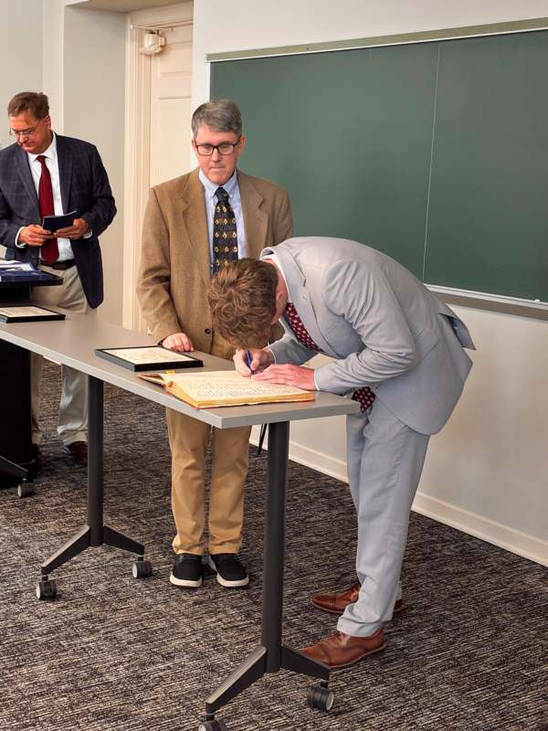 a man writing on a book