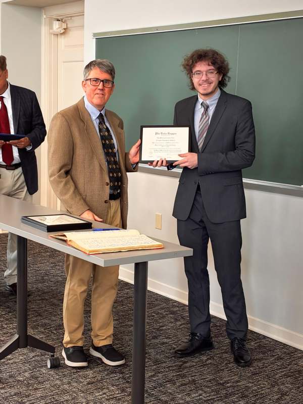 a man holding a certificate