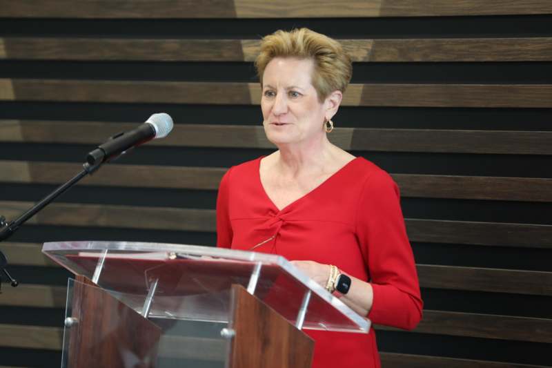 a woman standing at a podium