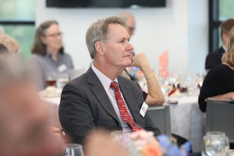 a man in a suit and tie sitting at a table