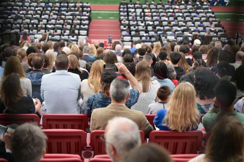 a group of people sitting in a stadium