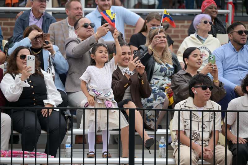 a group of people sitting on bleachers