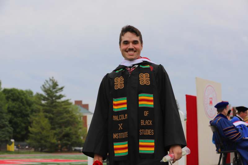 a man wearing a graduation gown