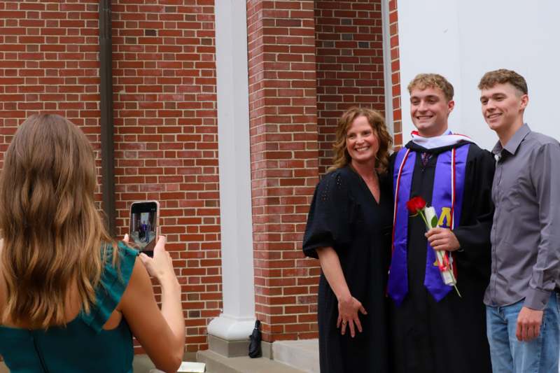 a man taking a picture of a woman and a woman