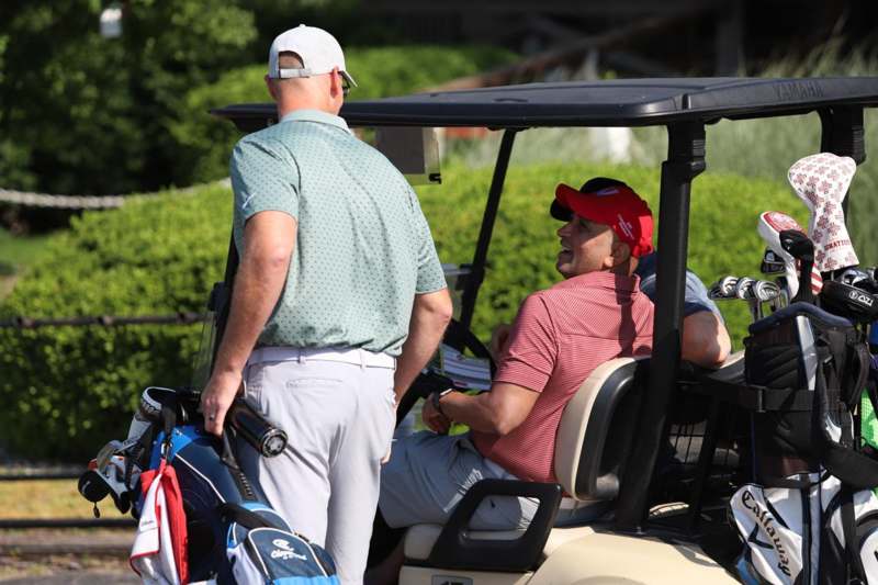 a group of men in golf carts