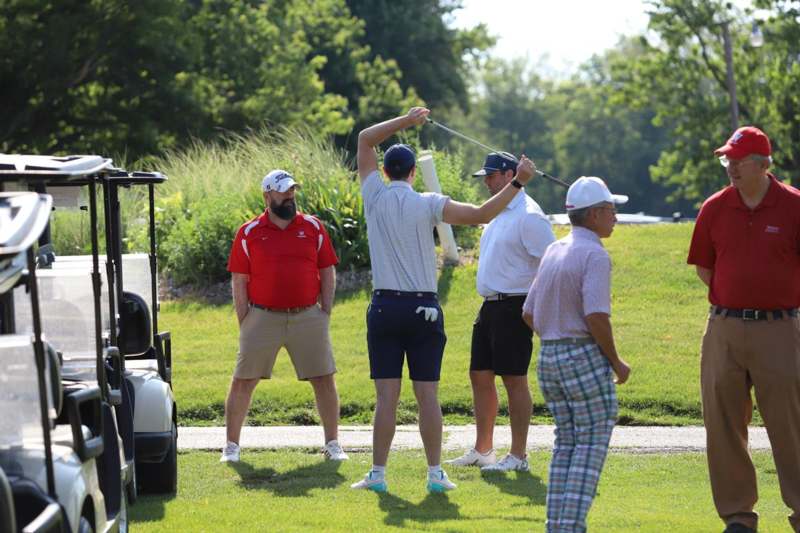 a group of men on a golf course