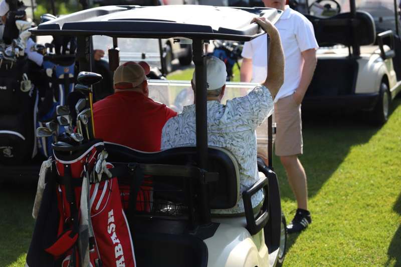 two men in a golf cart