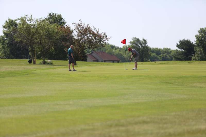 a group of people playing golf