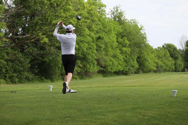 a man swinging a golf club
