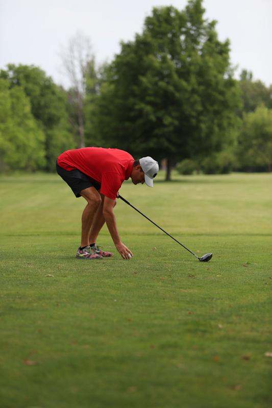 a man holding a golf club