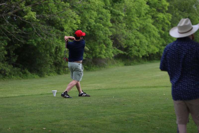 a man swinging a golf club